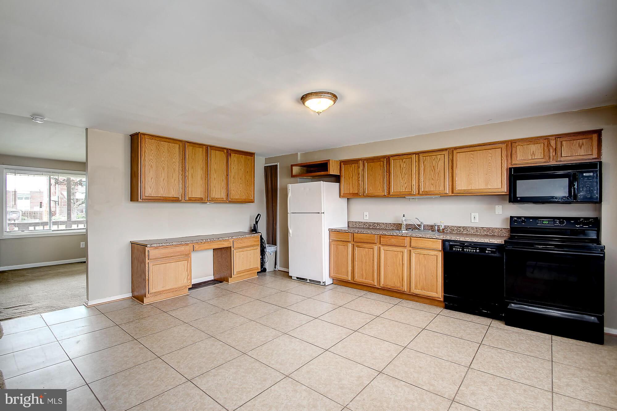 8036 Wynbrook Road Baltimore, MD 21224 - Photo 2 of 30 a kitchen with stainless steel appliances granite countertop a stove a sink and a microwave