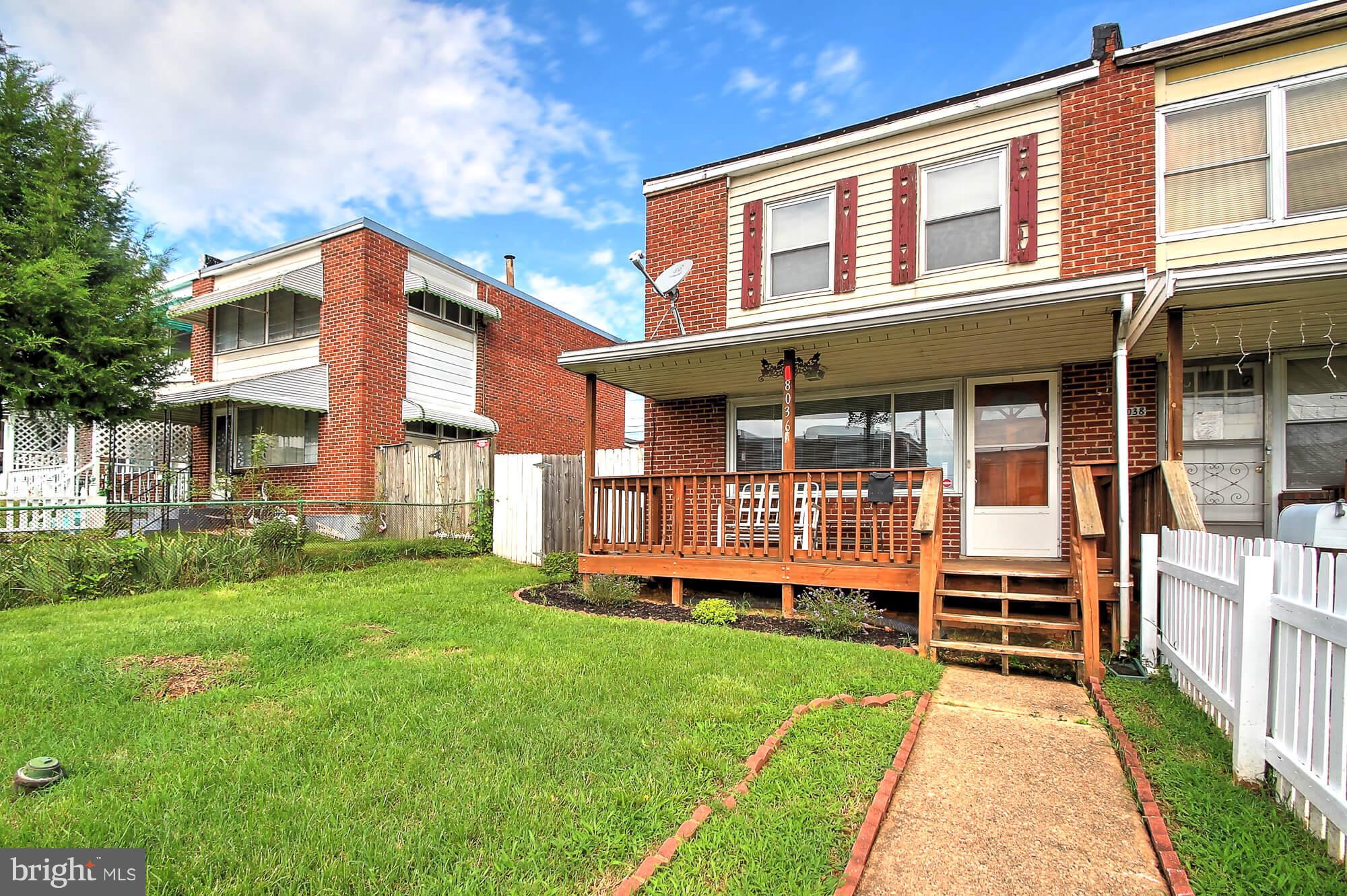 8036 Wynbrook Road Baltimore, MD 21224 - Photo 26 of 30 a front view of a house with a yard table and chairs