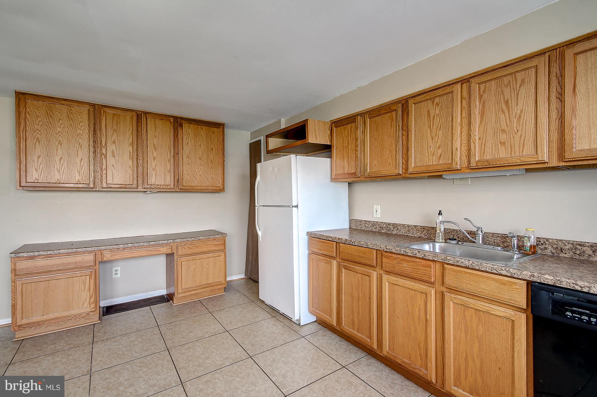 8036 Wynbrook Road Baltimore, MD 21224 - Photo 4 of 30 a kitchen with a sink dishwasher stove and refrigerator