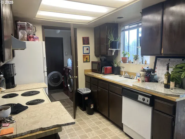 a kitchen with a sink stove and refrigerator