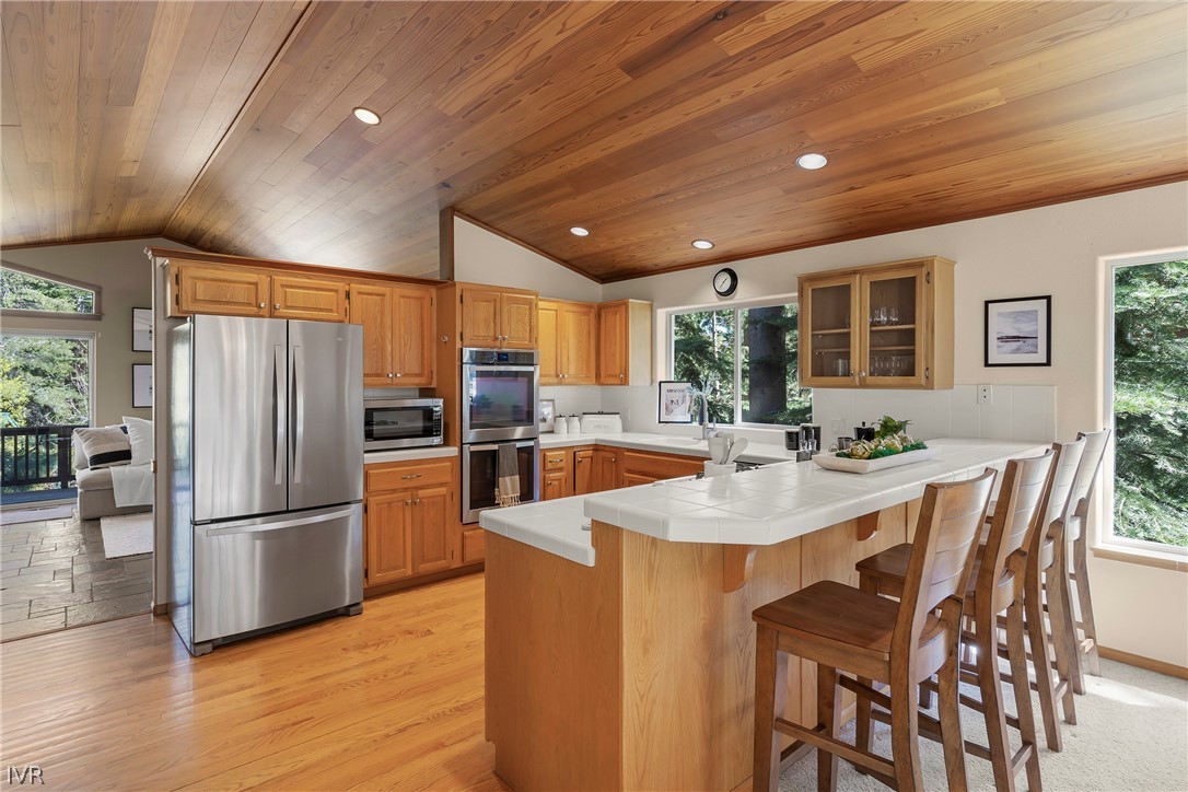 858 Jennifer Street Incline Village, NV 89451 - Photo 15 of 44 a kitchen with stainless steel appliances granite countertop a refrigerator a sink a stove a dining table and chairs