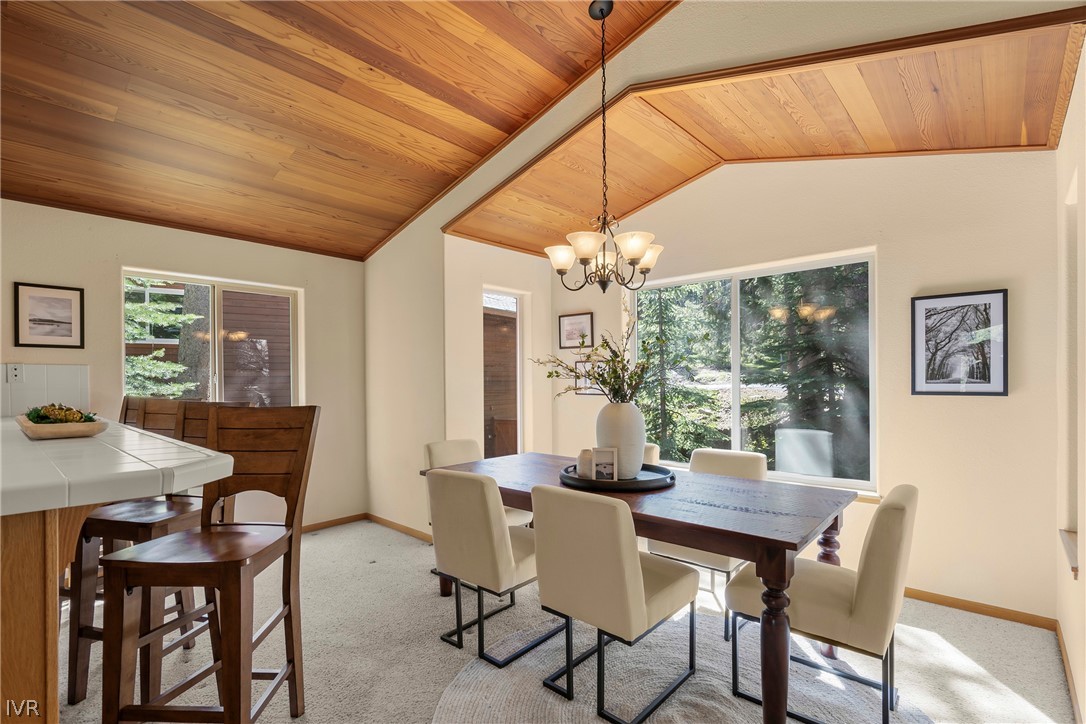 858 Jennifer Street Incline Village, NV 89451 - Photo 16 of 44 a dining room with furniture a chandelier and wooden floor