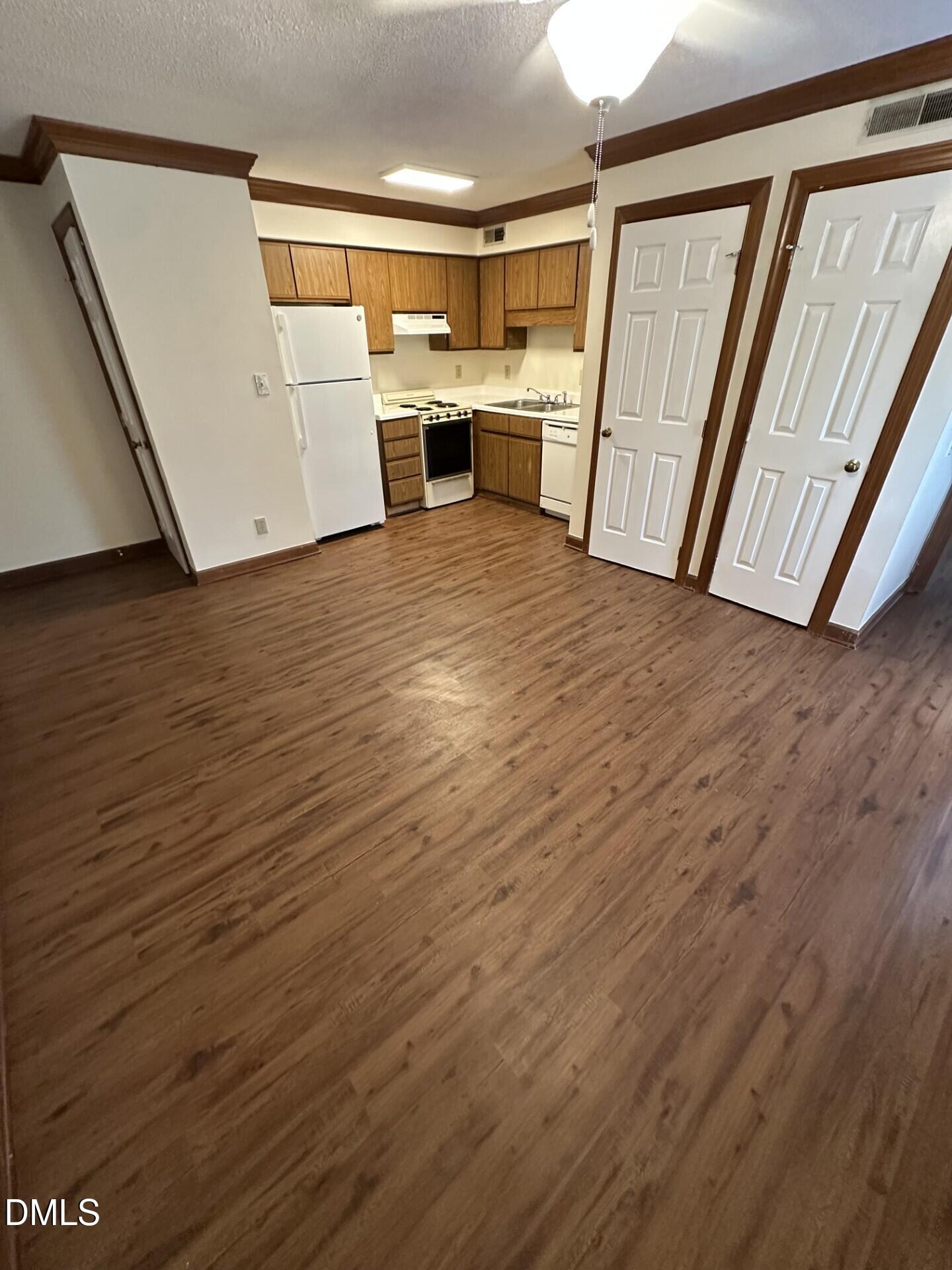 3520 Ivy Commons Drive, Unit 201 Raleigh, NC 27606 - Photo 2 of 7 a view of a kitchen with wooden floor