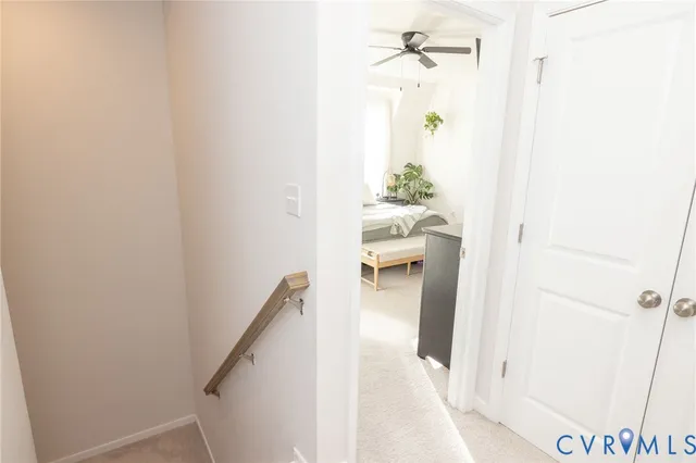 a bedroom with a bed and ceiling fan