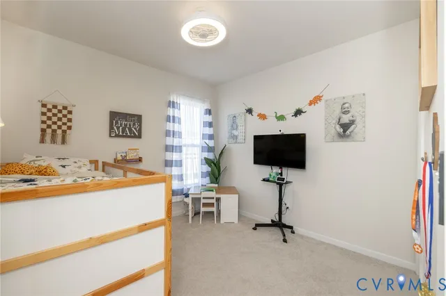 a white toilet sitting next to a white sink and a shower curtain