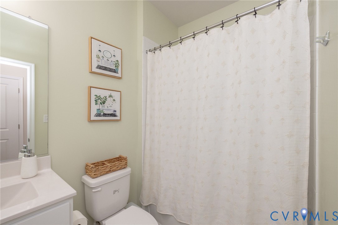 14435 Hancock Towns Drive Chesterfield, VA 23832 - Photo 29 of 34 a white toilet sitting next to a white sink and a shower curtain
