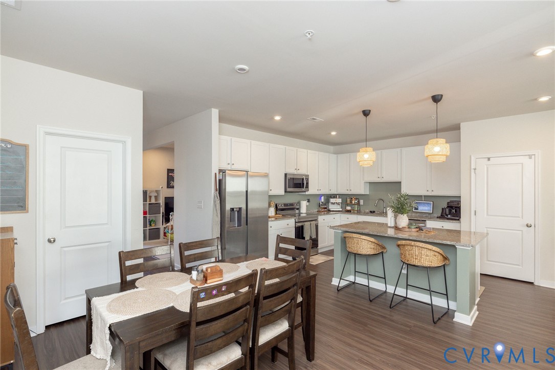 14435 Hancock Towns Drive Chesterfield, VA 23832 - Photo 6 of 34 a kitchen with a dining table chairs wooden floor appliances and cabinets