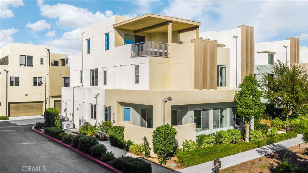 269 Magnet Irvine, CA 92618 - Photo 1 of 61 a front view of a multi story residential apartment building with yard and parking space
