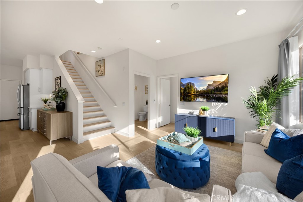 269 Magnet Irvine, CA 92618 - Photo 17 of 61 a living room with furniture a flat screen tv and a potted plant