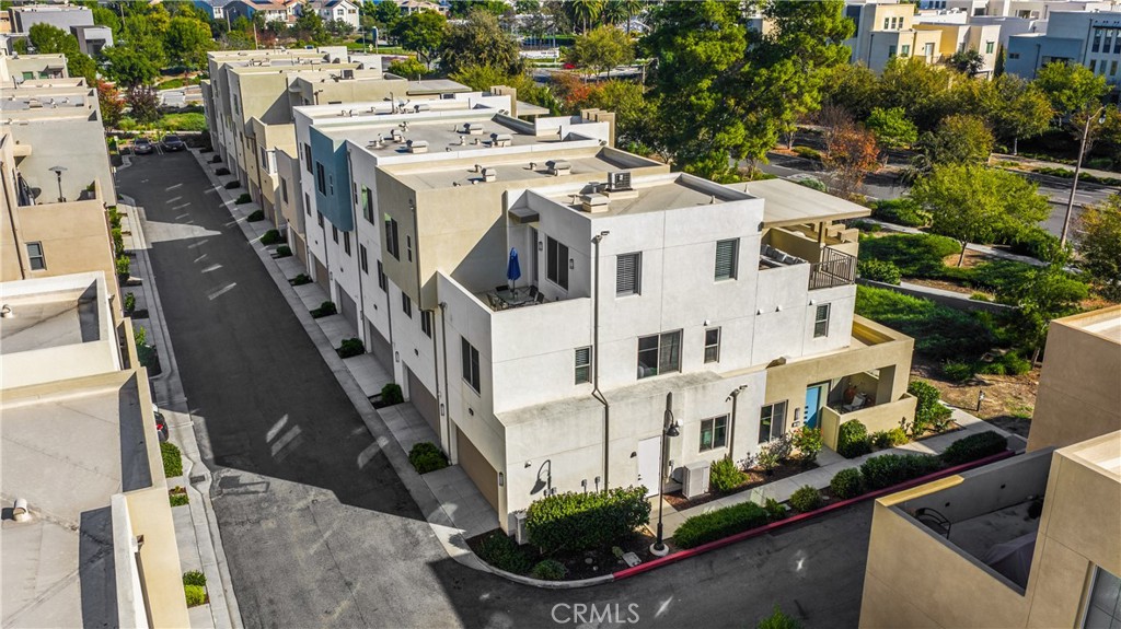 269 Magnet Irvine, CA 92618 - Photo 50 of 61 a view of a white house with large windows and a yard with table and chairs