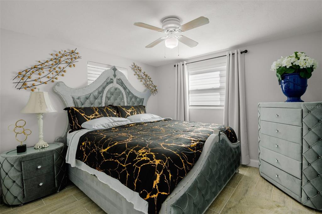 4149 Darlington Road Holiday, FL 34691 - Photo 21 of 34 a bedroom with a bed and a chandelier