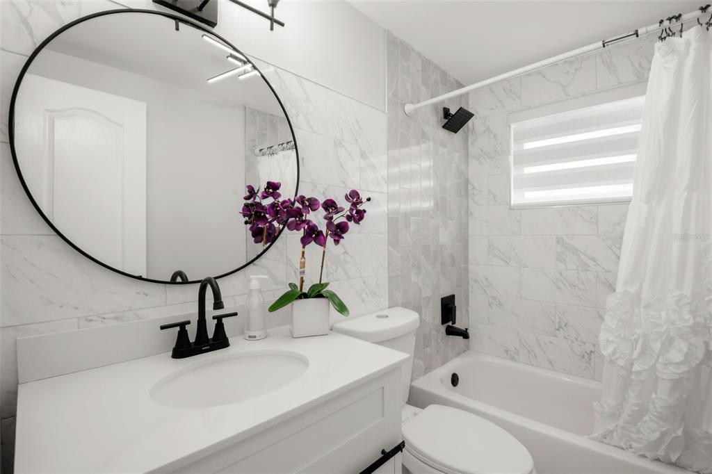 4149 Darlington Road Holiday, FL 34691 - Photo 23 of 34 a bathroom with a sink toilet and shower