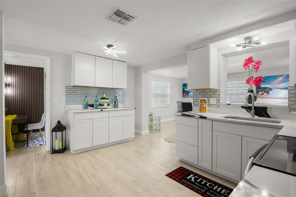 4149 Darlington Road Holiday, FL 34691 - Photo 24 of 34 a kitchen with granite countertop a sink cabinets and window