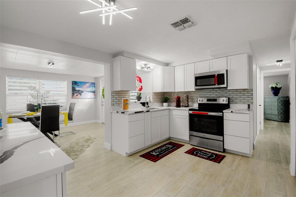 4149 Darlington Road Holiday, FL 34691 - Photo 25 of 34 a kitchen with sink cabinets and appliances