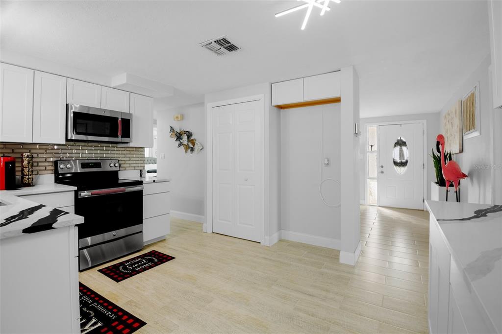 4149 Darlington Road Holiday, FL 34691 - Photo 26 of 34 a kitchen with stainless steel appliances a stove top oven a sink a refrigerator and a microwave
