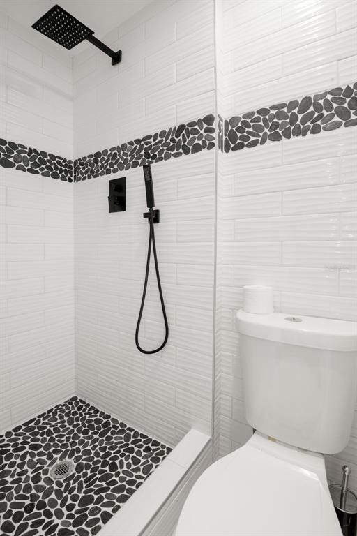 4149 Darlington Road Holiday, FL 34691 - Photo 31 of 34 a bathroom with a shower a toilet and a shower