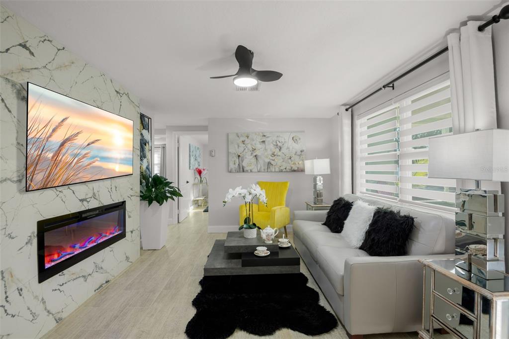 4149 Darlington Road Holiday, FL 34691 - Photo 9 of 34 a living room with furniture a fireplace and a flat screen tv