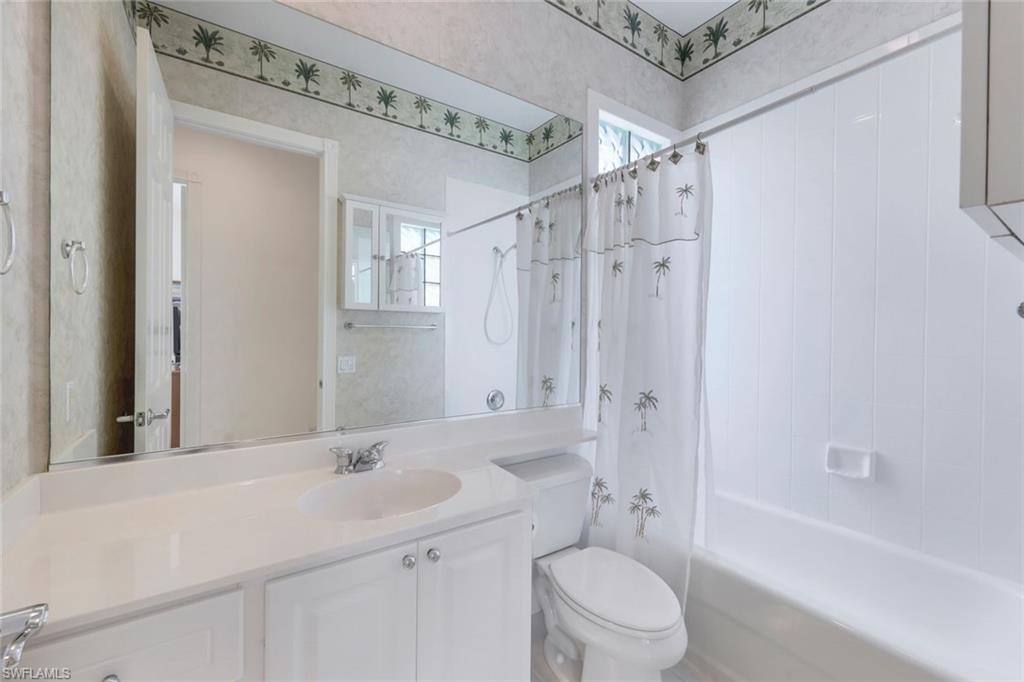 3059 Ellice Way Naples, FL 34119 - Photo 20 of 50 a bathroom with a sink a toilet and shower