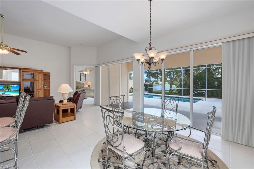 3059 Ellice Way Naples, FL 34119 - Photo 22 of 50 a view of a dining room with furniture wooden floor and chandelier