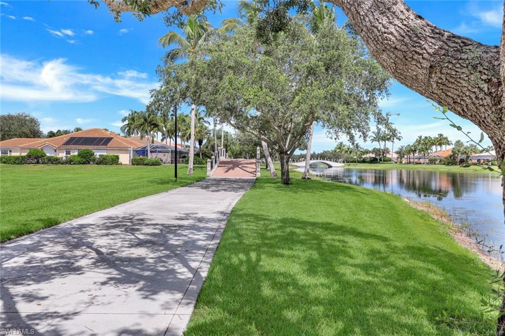 3059 Ellice Way Naples, FL 34119 - Photo 32 of 50 a view of a lake with a building in the background
