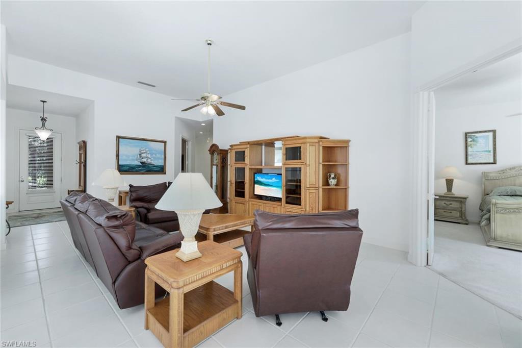 3059 Ellice Way Naples, FL 34119 - Photo 6 of 50 a living room with furniture and a flat screen tv