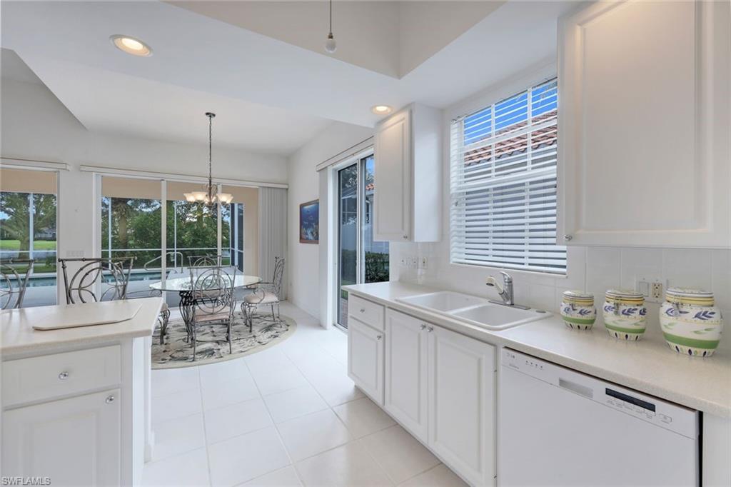 3059 Ellice Way Naples, FL 34119 - Photo 7 of 50 a dining hall with stainless steel appliances granite countertop a sink and a large window