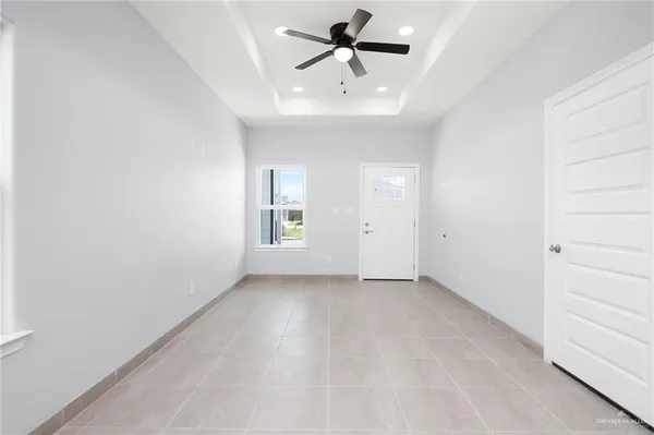 an empty room with a empty space and a ceiling fan