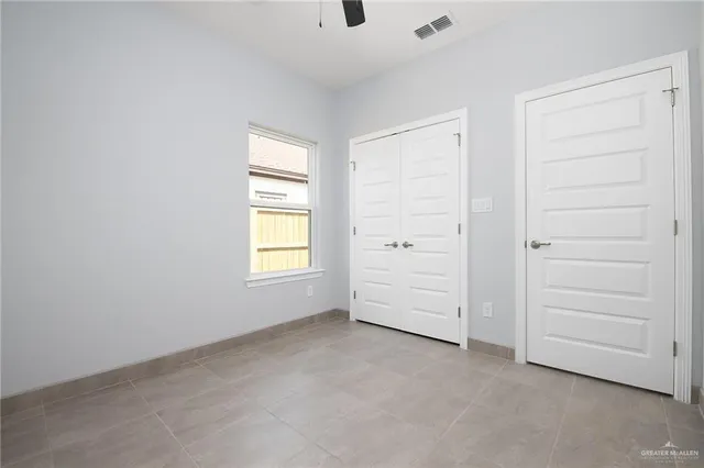 an empty room with closet and cabinet