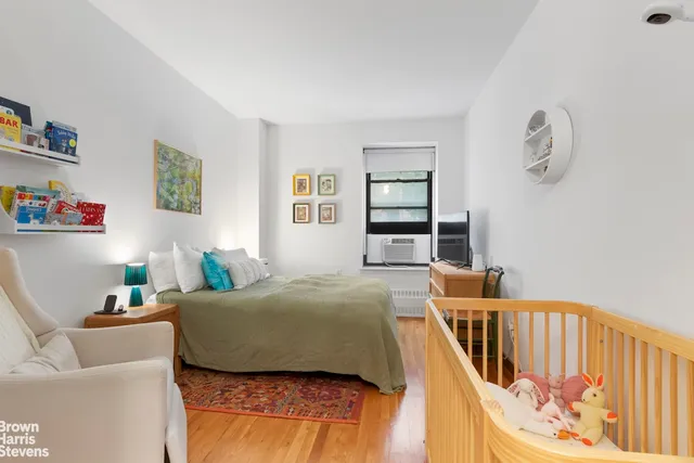a picture of a room with a white bed and a white wall