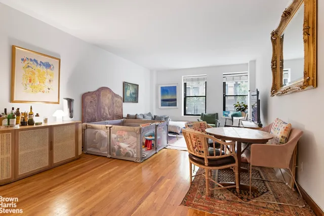 a picture of a room with a white bed and a white wall
