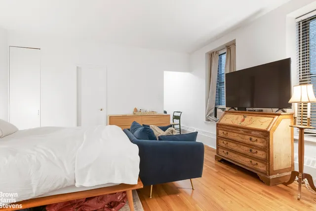 a kitchen with granite countertop a dining table chairs and wooden floor