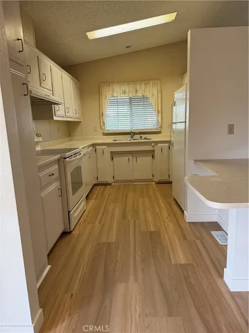 a kitchen with a sink a refrigerator and window
