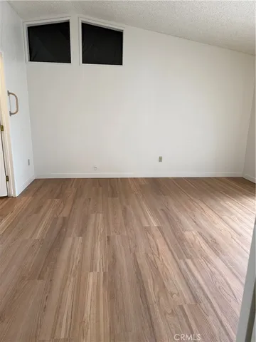 a view of a room with wooden floor