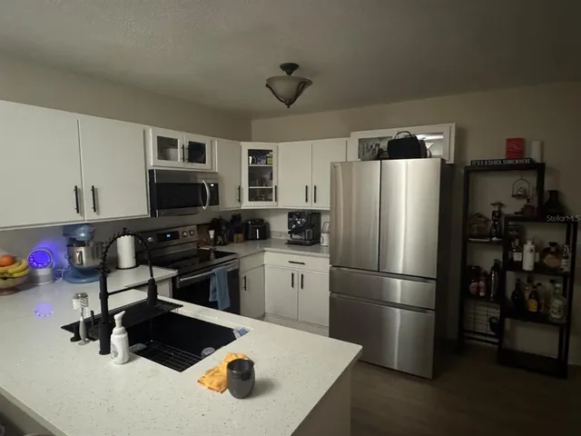 a kitchen with a refrigerator stove and microwave