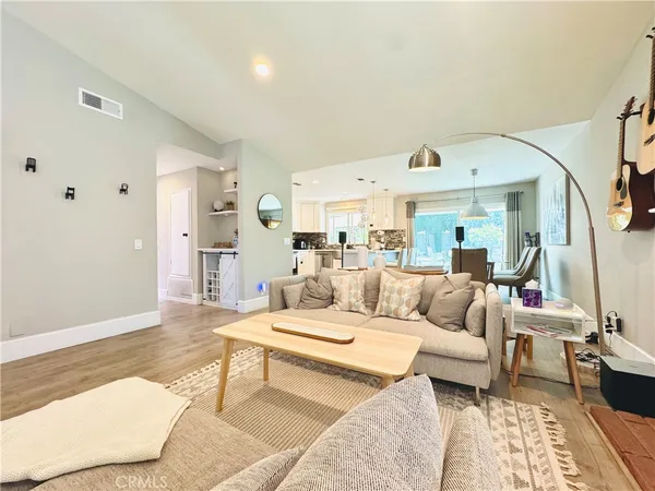 a living room with furniture wooden floor and a rug