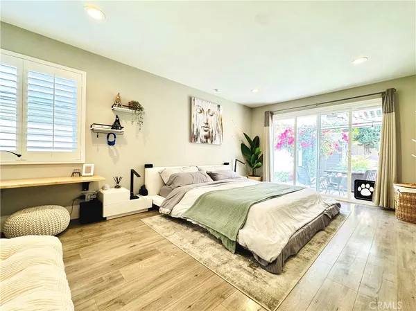 a spacious bedroom with a bed and a couch