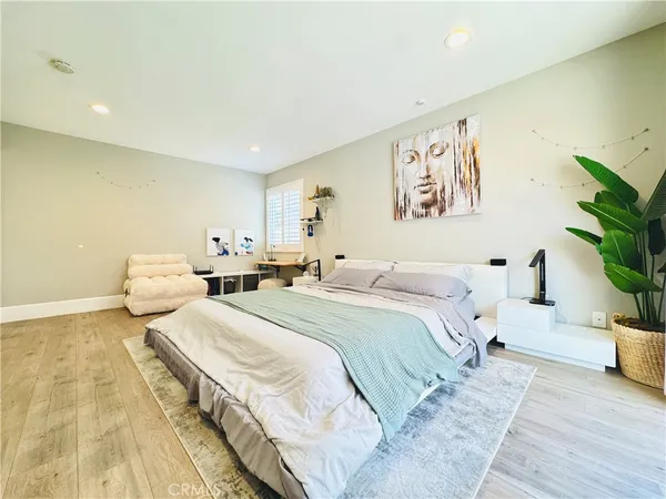 a bed room with two beds and potted plant