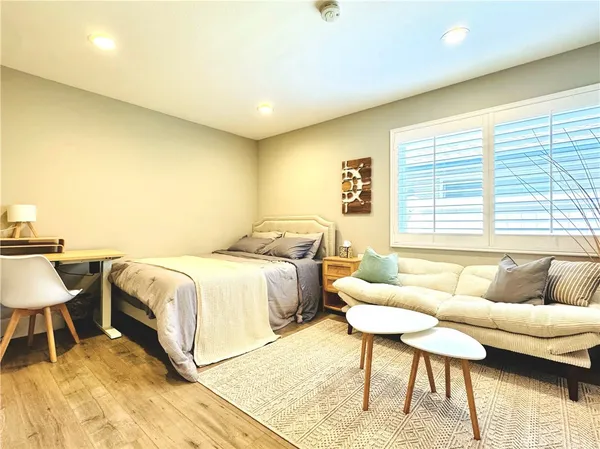 a spacious bedroom with a bed and a couch