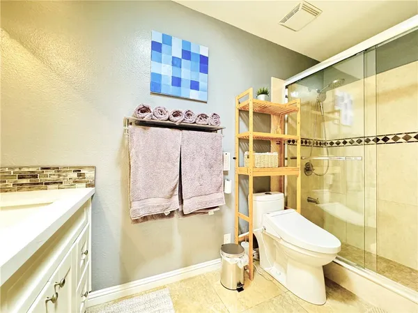 a bathroom with a toilet sink and shower