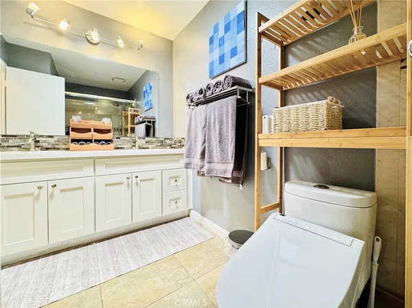 a bathroom with a sink a toilet and mirror