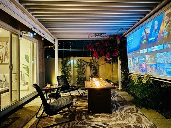 a view of a chairs and table in patio