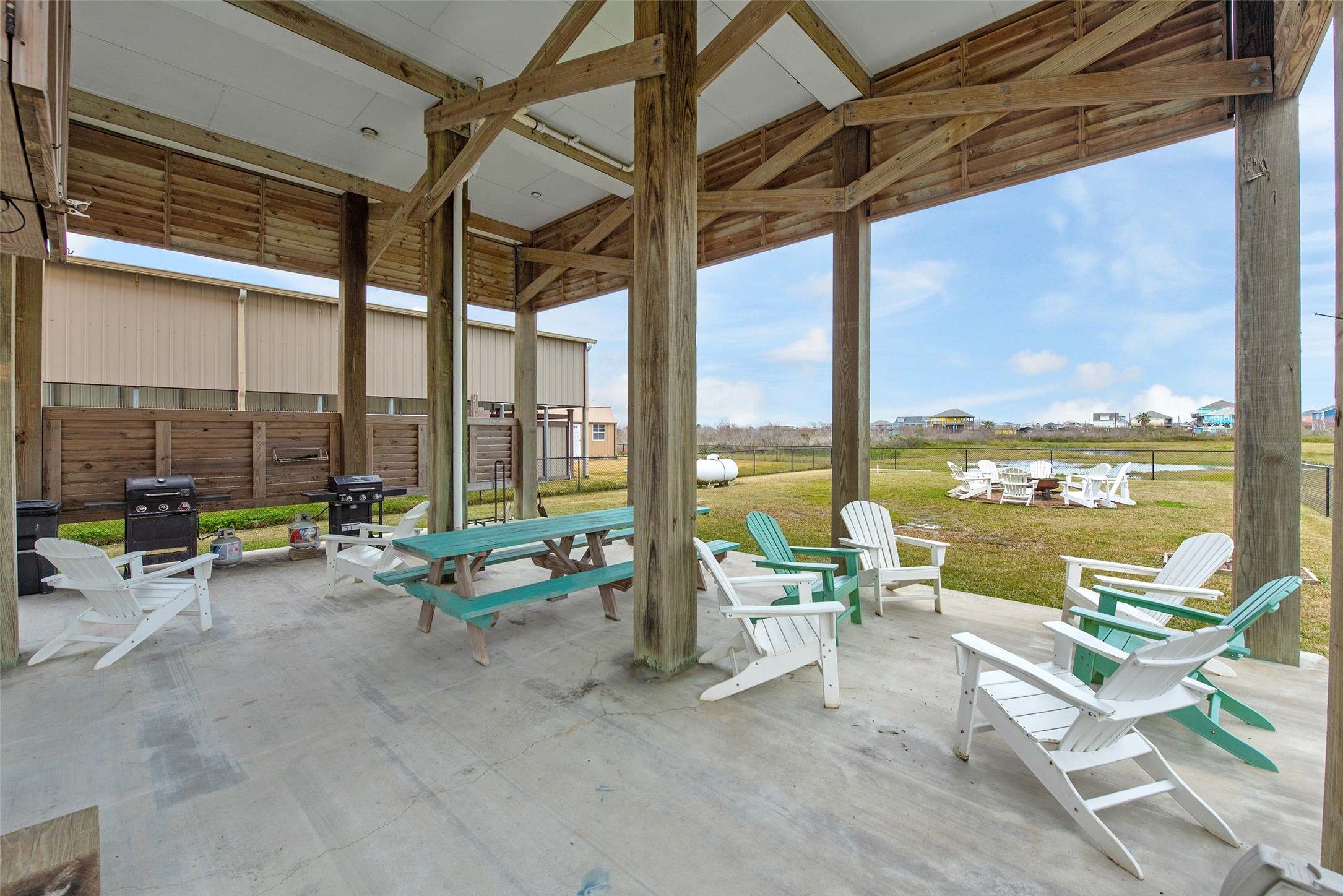 858 South East Road Crystal Beach, TX 77650 - Photo 14 of 44 a living room with furniture and floor to ceiling windows