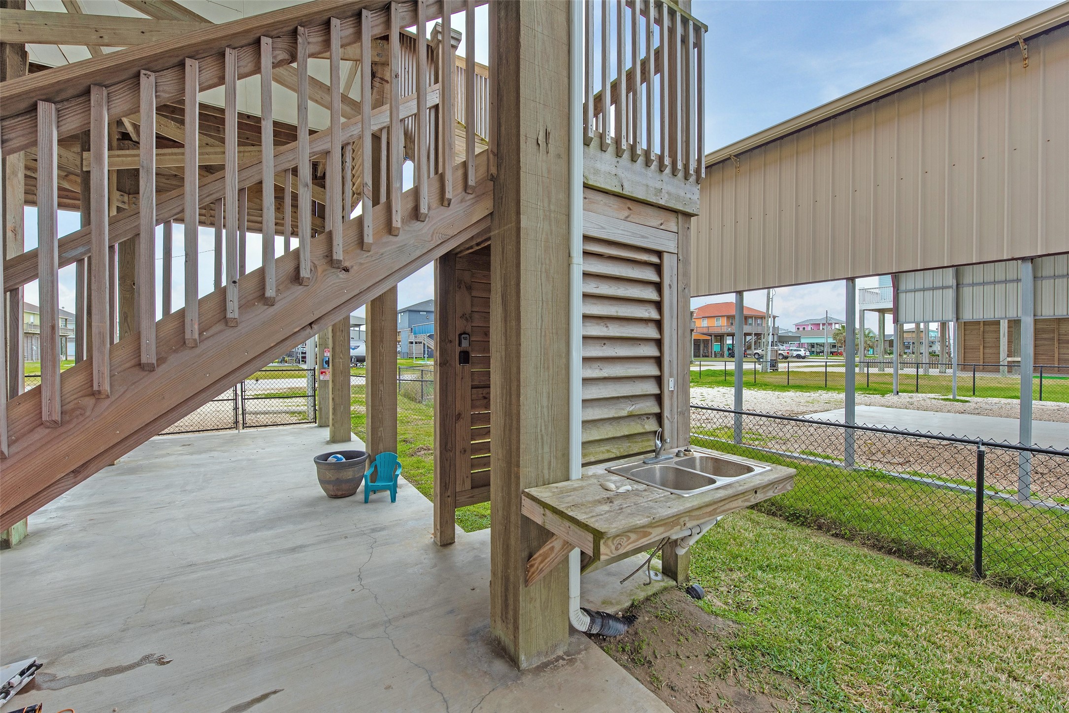 858 South East Road Crystal Beach, TX 77650 - Photo 16 of 44 a view of a chairs with barbeque grill and wooden fence