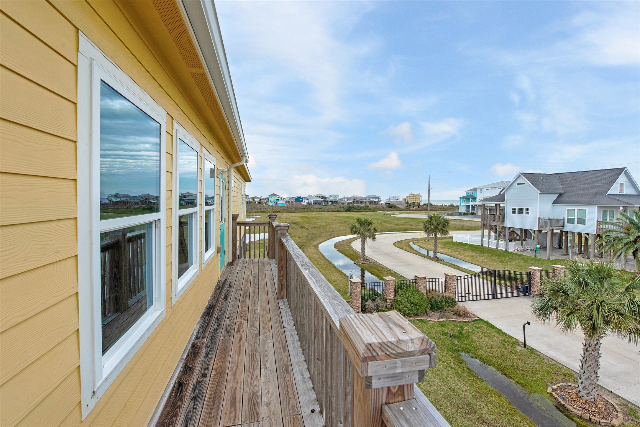 858 South East Road Crystal Beach, TX 77650 - Photo 19 of 44 a view of a balcony with wooden floor and fence