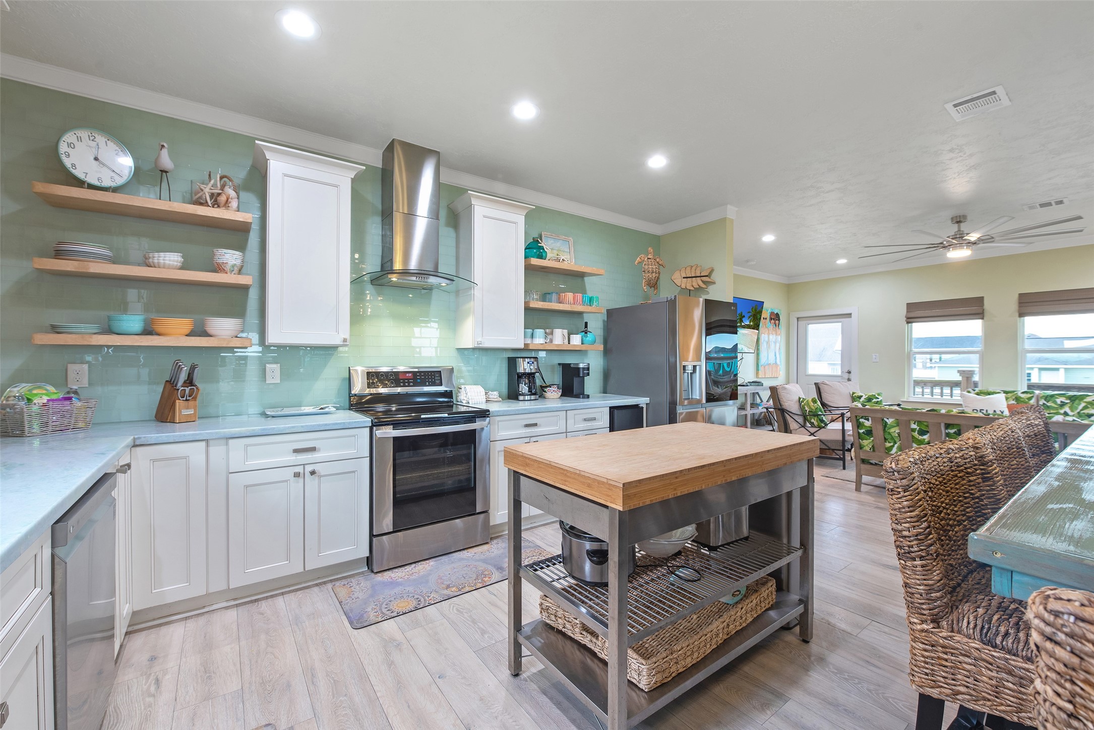 858 South East Road Crystal Beach, TX 77650 - Photo 29 of 44 a kitchen with a stove cabinets and chairs