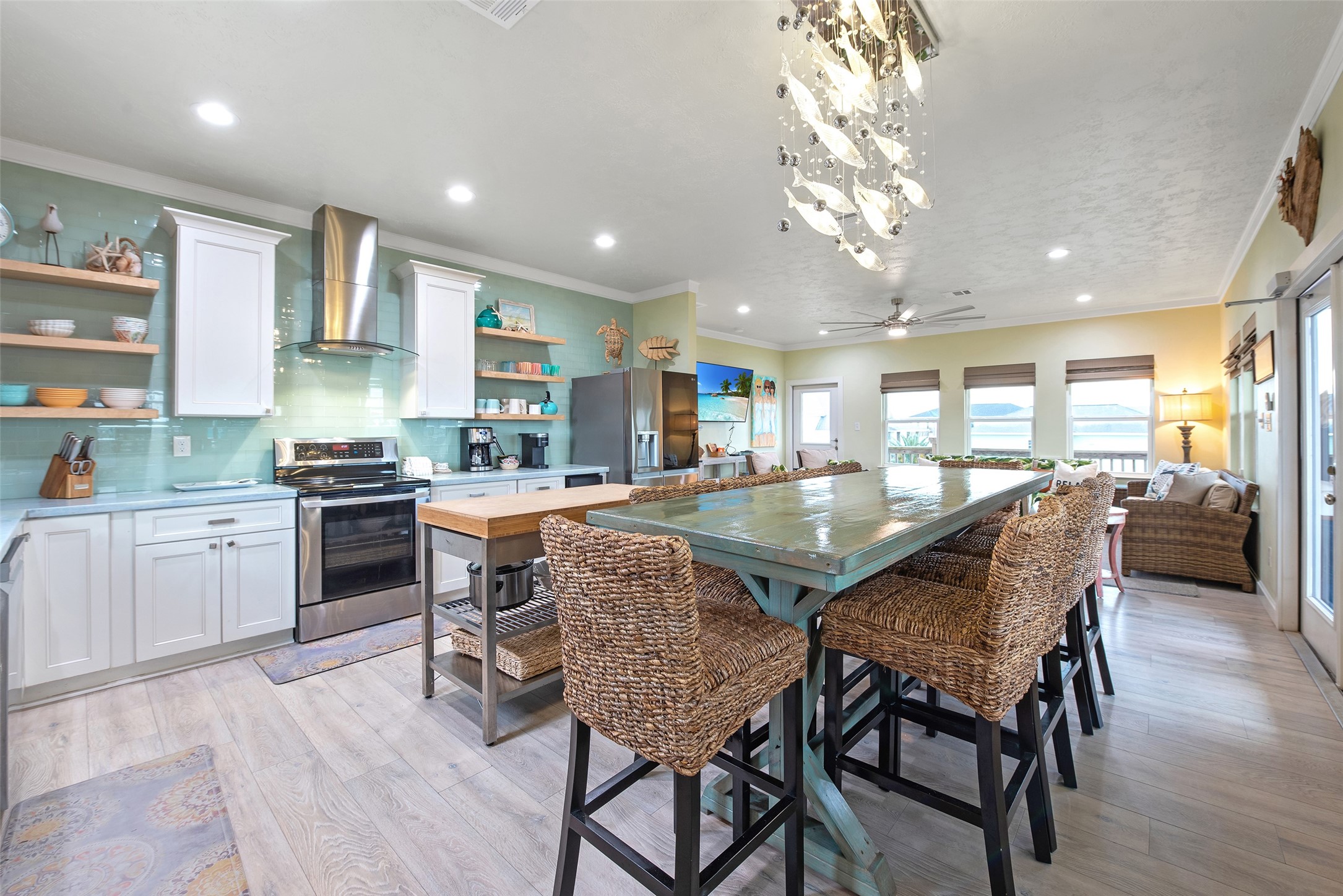 858 South East Road Crystal Beach, TX 77650 - Photo 30 of 44 a kitchen with a table chairs microwave and cabinets