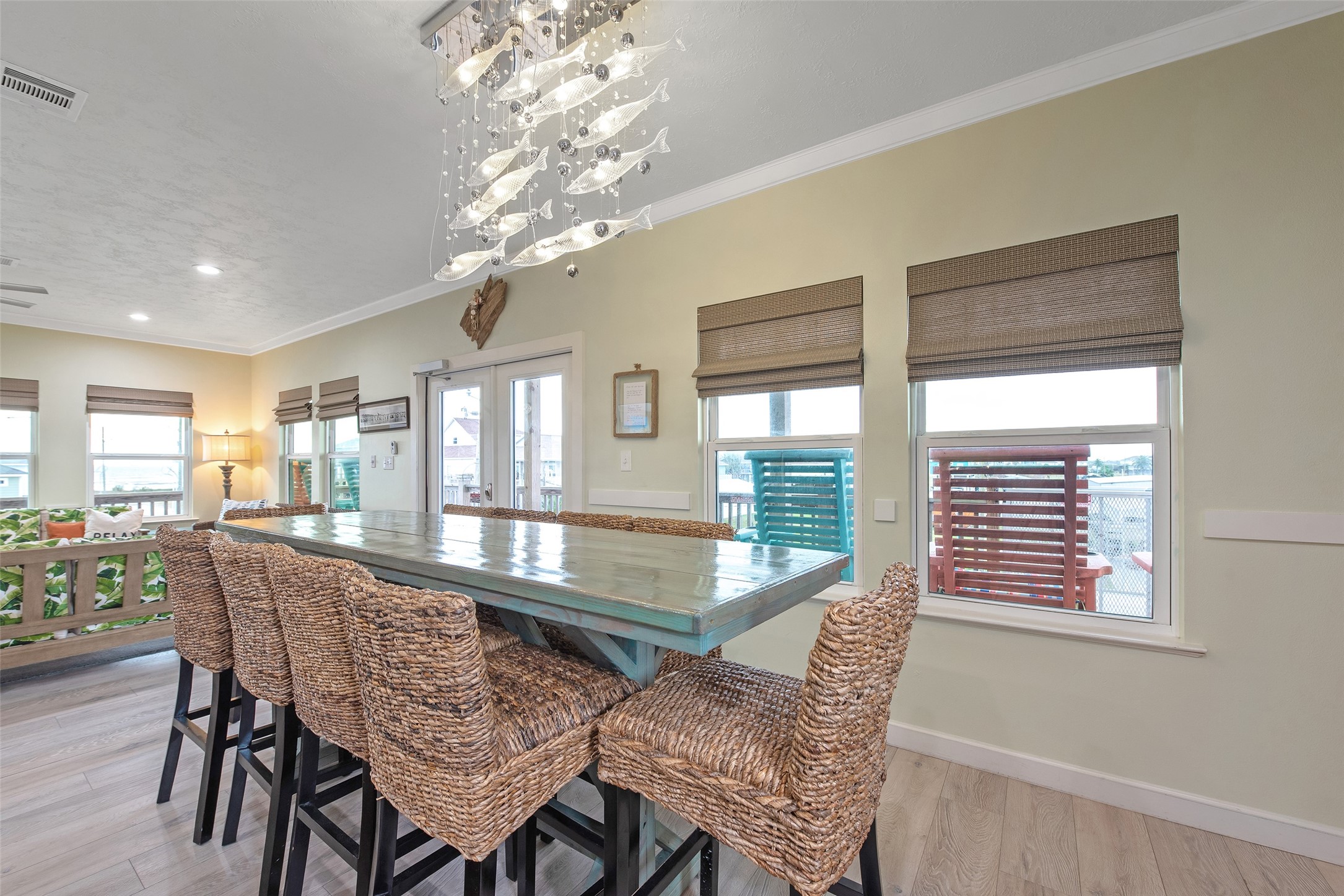 858 South East Road Crystal Beach, TX 77650 - Photo 33 of 44 a dining room with furniture a chandelier and wooden floor