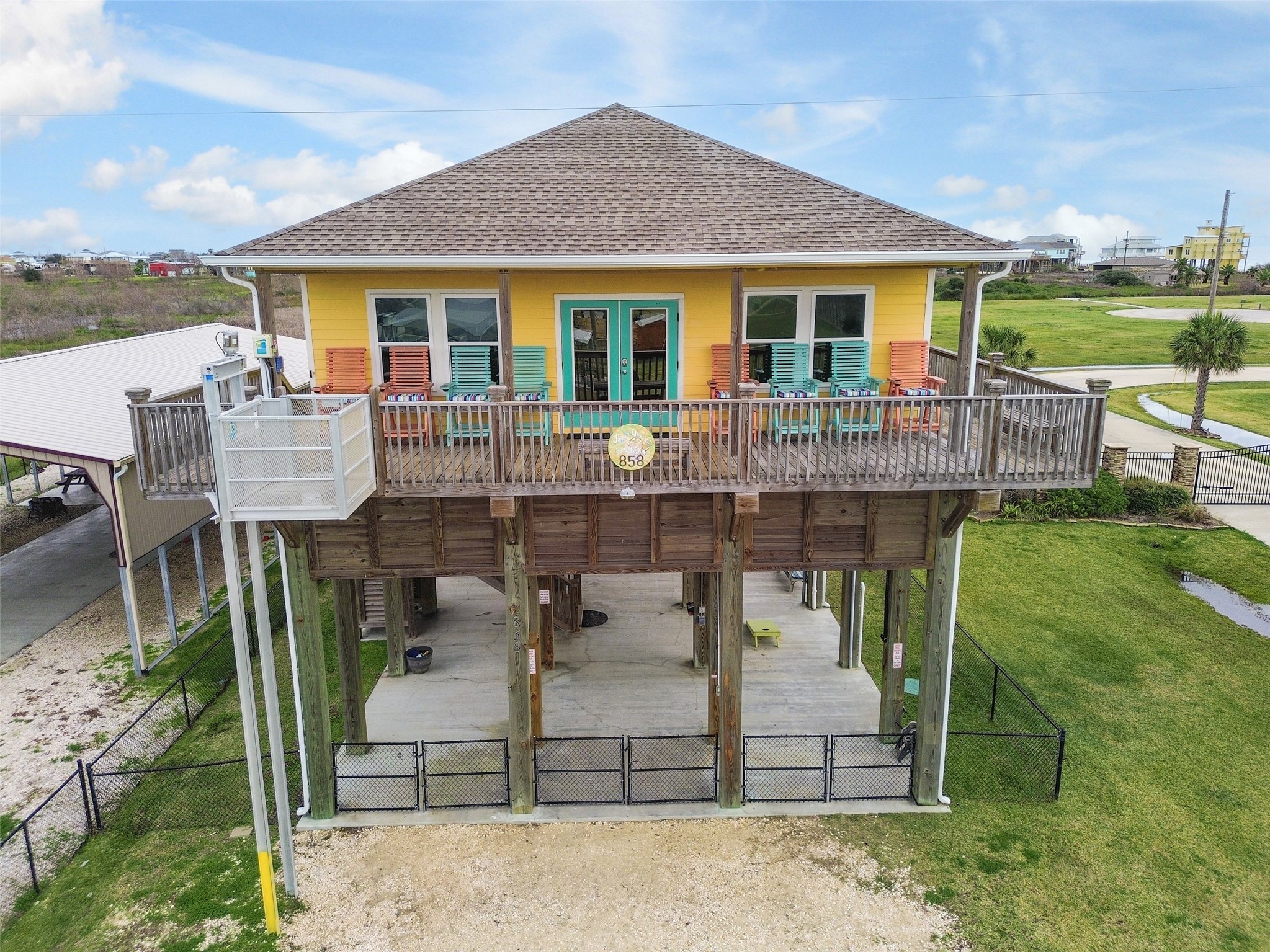858 South East Road Crystal Beach, TX 77650 - Photo 5 of 44 a front view of a house with a yard table and chairs