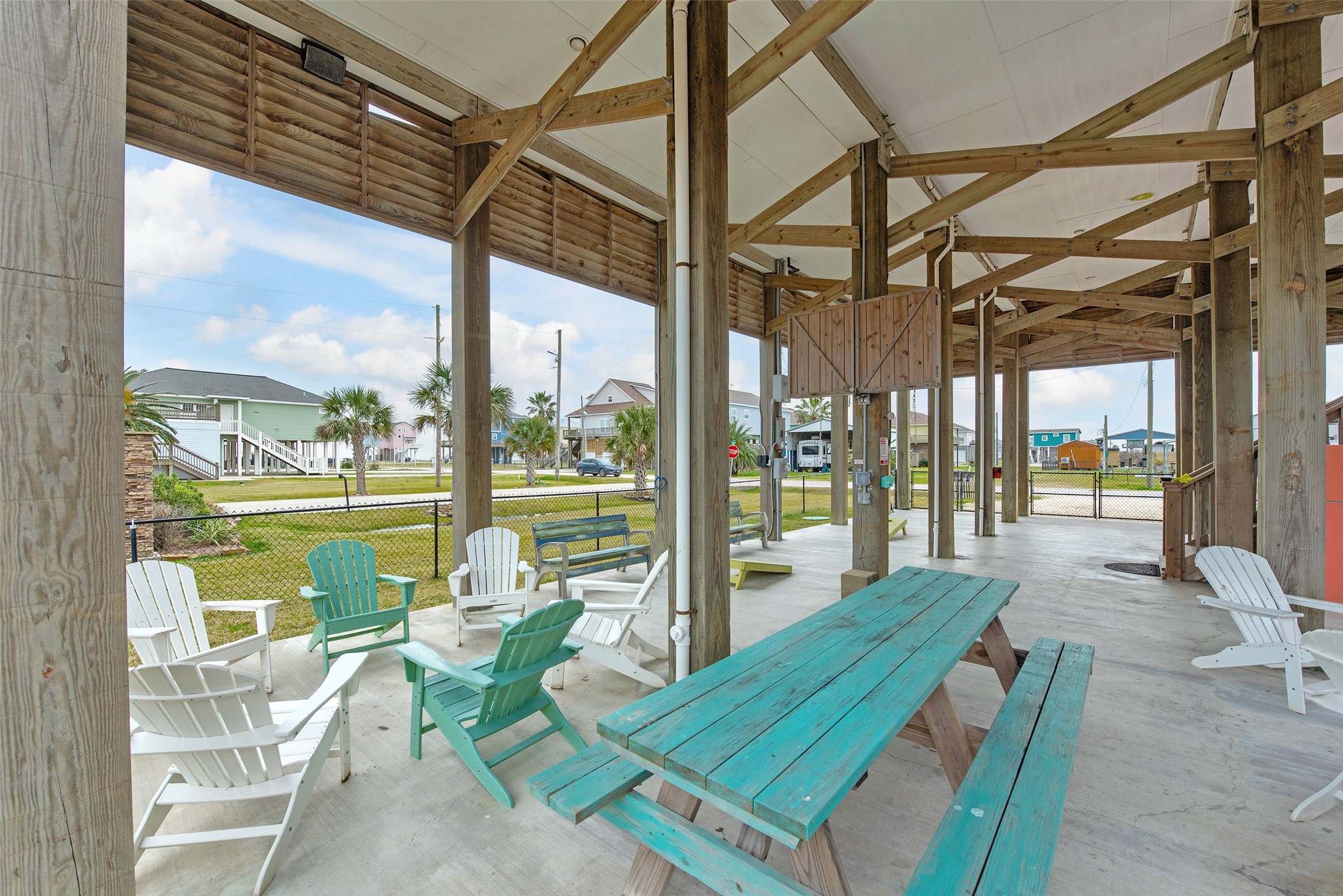 858 South East Road Crystal Beach, TX 77650 - Photo 10 of 44 a view of a patio with a table chairs and balcony