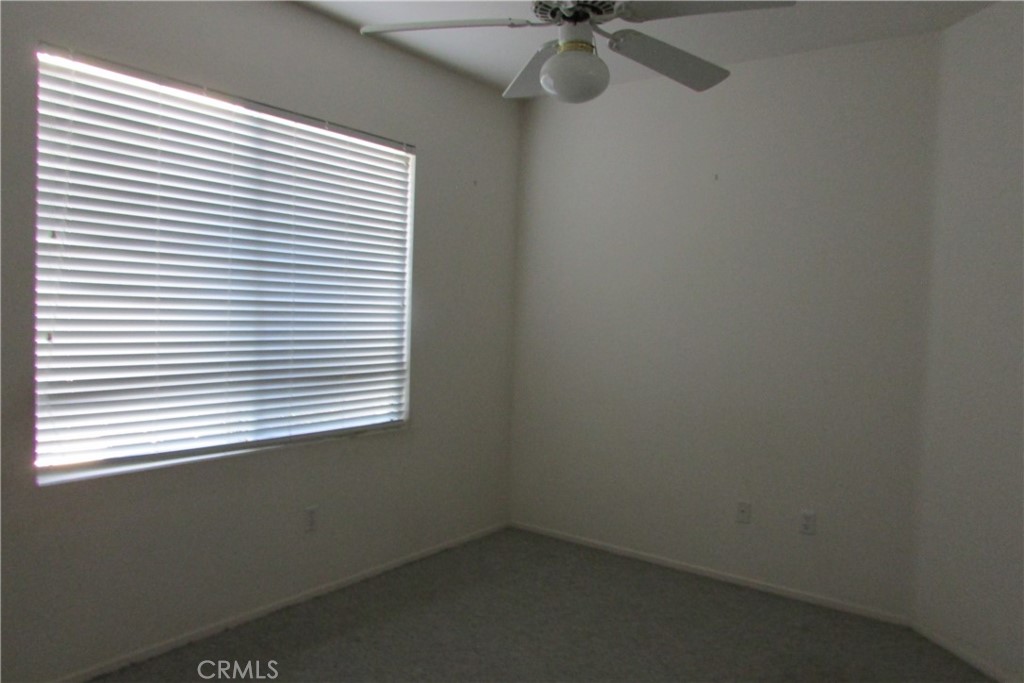 78281 Bovee Circle Palm Desert, CA 92211 - Photo 22 of 38 an empty room with a window and a fan